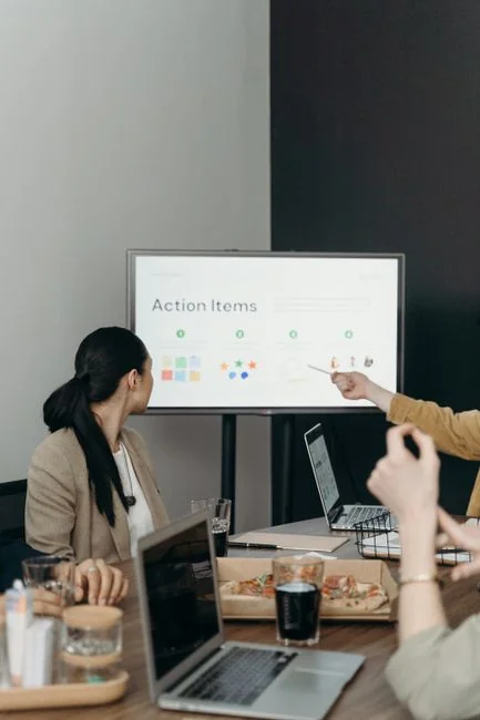 A man uses a laptop indoors to analyze stock market trends graph on screen.